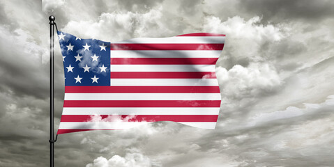 United States national flag cloth fabric waving on beautiful sky grey Background.