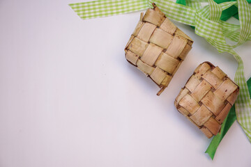 Ketupat, diamond shape steamed rice on white background. Space for text.