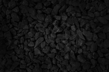 Fototapeta premium Black gray pebbles texture background, small stone gravel for garden decoration.