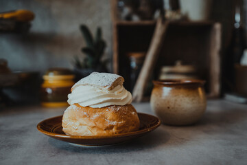 Bun with whipped cream on plate