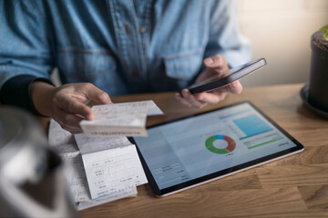 Woman organizing household budget with digital tablet