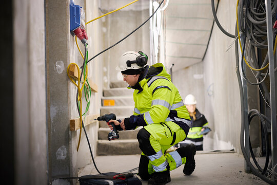 Construction worker using electric drill