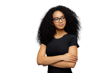 Photo of thoughtful satisfied Afro woman keeps hands crossed over chest, focused aside, wears transparent glasses, casual black t shirt, isolated over blue background. Human facial expressions concept