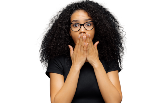Photo of stupefied young female covers mouth, has bated breath, bugged eyes, Afro hair, cannot believe in shocking news, wears casual black t shirt, stands over blue background. Omg concept.