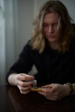 Sad man holding pill box