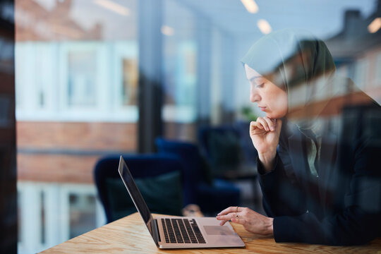 Woman in cafe using laptop