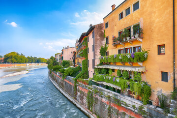 Fototapeta na wymiar Astonishing Verona cityscape view on the riverside with historical buildings ,bridges and tower