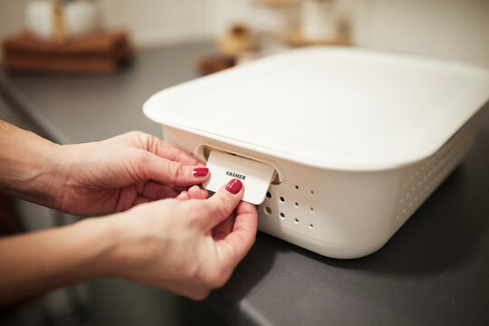 Woman's Hands Putting Label On Basket