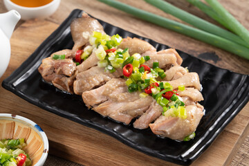 Delicious sliced chicken with scallion oil sauce, close up.