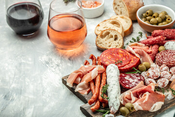 traditional Spanish tapas chorizo, jamon serrano. Cured meat and cheese platter with wine. Mixed...