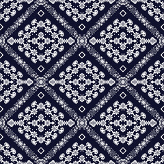 Abstract floral patterned turban. White on a navy blue background. Seamless pattern.
