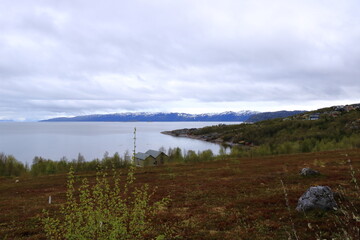 Beautiful landscape picture along the coast in Alta, Norway with beautiful mountains in the background of the sea in summer