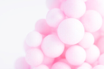 Colorful balls background in pink colors. Background with balls in different sizes. Sphere of balls on pastel color..