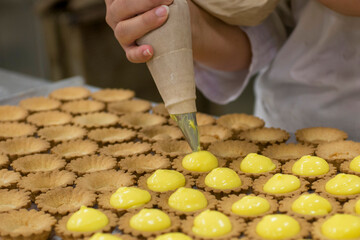 artisanal preparation of pastry desserts - custard on shortbread biscuits
