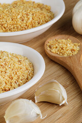 Minced Garlic isolated on a wooden background