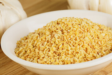 Minced Garlic isolated on a wooden background