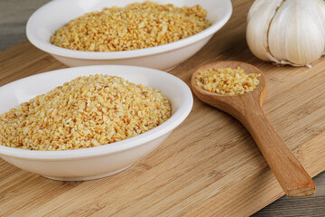 Minced Garlic isolated on a wooden background