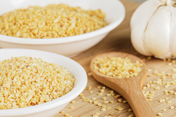 Minced Garlic isolated on a wooden background