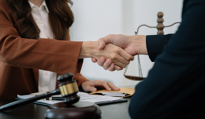partner lawyers attorneys shaking hands after discussing a contract agreement done.