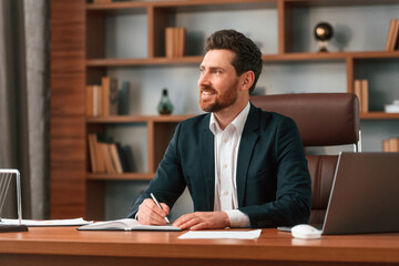 Thinking, having an idea. Businessman in formal clothes is working indoors