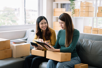 Small business woman Worker delivery service and working packing box, business owner working checking order to confirm before sending customer in post office.