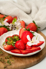 Fresh strawberries on a plate with flowers