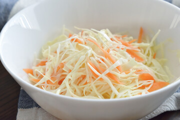Coleslaw salad with cabbage and carrot.  Healthy and dietary food concept. Selective focus. 
