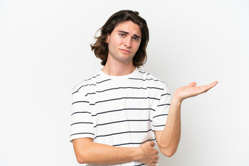 Young handsome man isolated on white background having doubts