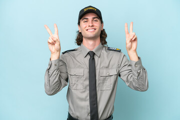 Young safeguard man isolated on blue background showing victory sign with both hands