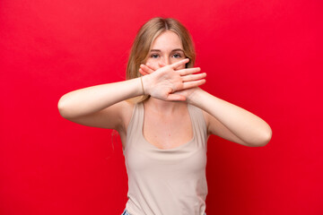 Young English woman isolated on red background making stop gesture with her hand to stop an act