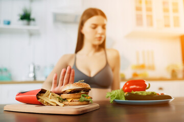 Woman on dieting for good health concept. Woman doing cross arms sign to refuse junk food or fast...