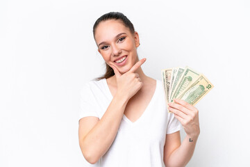 Young caucasian woman taking a lot of money isolated on white background happy and smiling