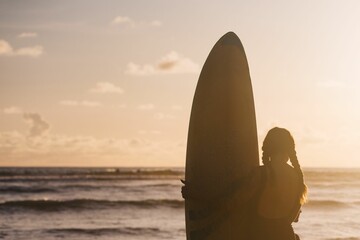 Fototapeta na wymiar Surfers on the beach, surfing themed photograph