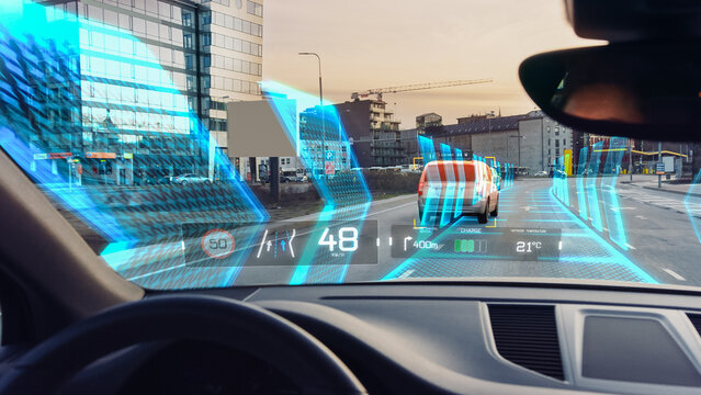 Futuristic Autonomous Self-Driving Concept Car Moving Through City, Head-up Display HUD Showing Infographics: Speed, Distance, Navigation, Fuel. AI Road Scanning. Driver Seat Point of View POV / FPV. - Powered by Adobe