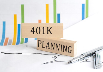 401 K PLANNING text on a wooden block on chart background , business concept