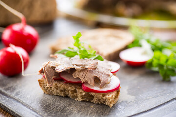 sandwich with baked meat, radish and herbs