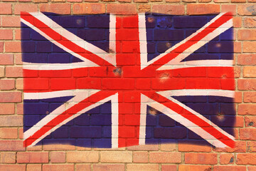 Fototapeta premium The British flag is painted on a brick wall