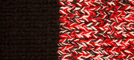 Handmade knitted fabric black white and red wool background texture