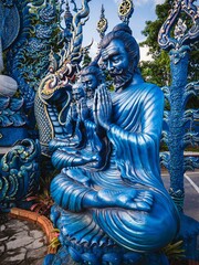 Fototapeta premium Blue god spirit Buddhist deity at Chiang Rai's Wat Rong Suea Ten (Blue Temple)