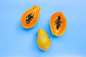 Papaya fruit on blue background.