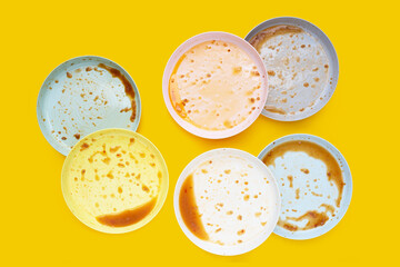 Dirty dishes on yellow background. Top view