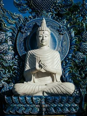 Papier Peint photo Monument historique White Buddha idol statue at Chiang Rai's Wat Rong Suea Ten (Blue Temple)