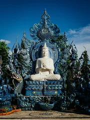 Zelfklevend Fotobehang Historisch monument White Buddha idol statue at Chiang Rai's Wat Rong Suea Ten (Blue Temple)