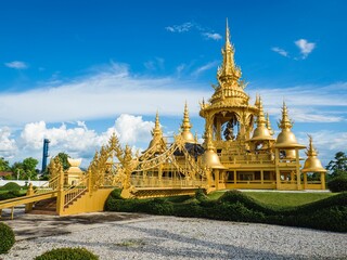 Naklejka premium Beautiful Wat Rong Khun White Temple with golden buildings in Chiang Rai, Thailand