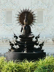 Tuinposter Historisch monument A beautiful Buddha idol statue in Wat Rong Khun White Temple, Chiang Rai, Thailand