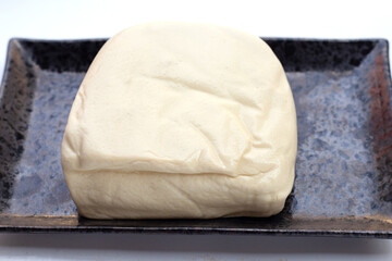 White tofu in black plate on white background