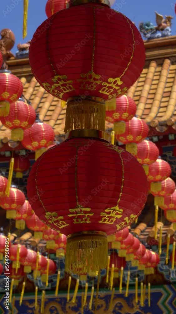 Wall mural red lanterns sways in the breeze in a chinese temple. vertical video