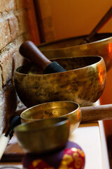 Tibetan copper singing bowls with mace, with brick wall