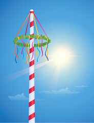 maypole with colorful ribbons on blue sunny sky background