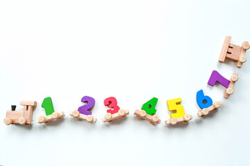 Wooden train with numbers on a white isolated background. Children's educational logic toys are...